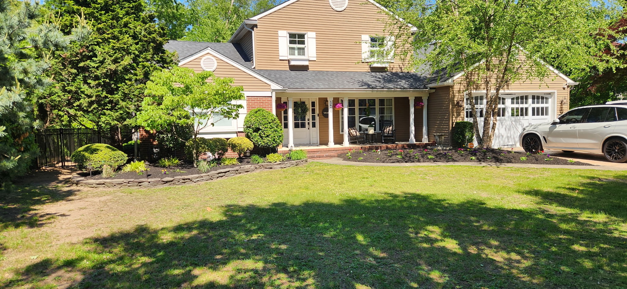 Maintained front lawn with landscaped beds and rock edging