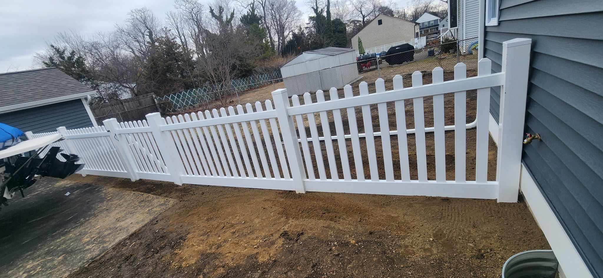 White vinyl picket fence installation