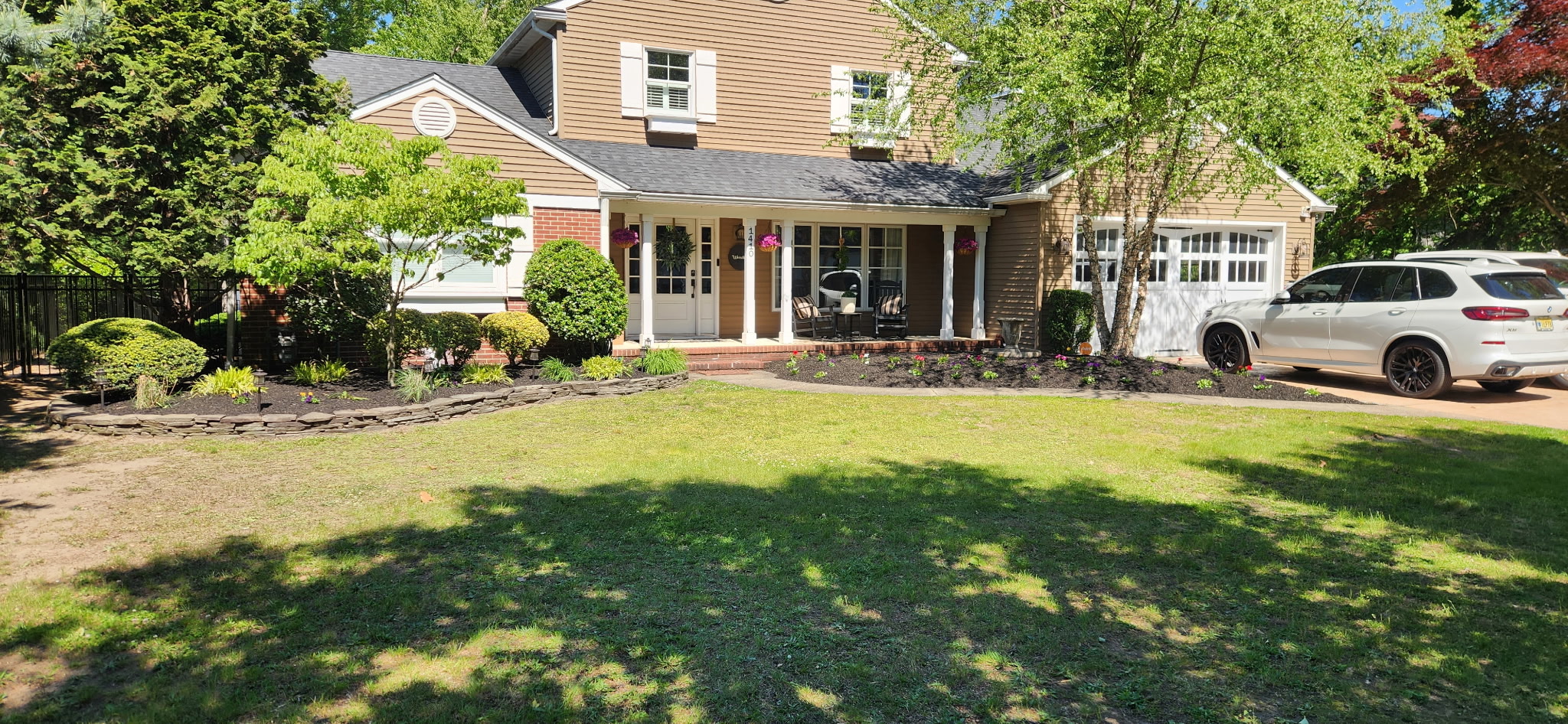 Front yard with fresh mulch beds and maintained landscaping
